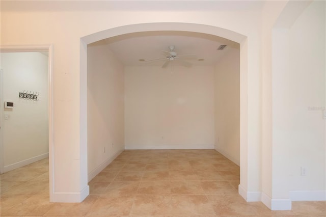 spare room with ceiling fan and light tile patterned floors