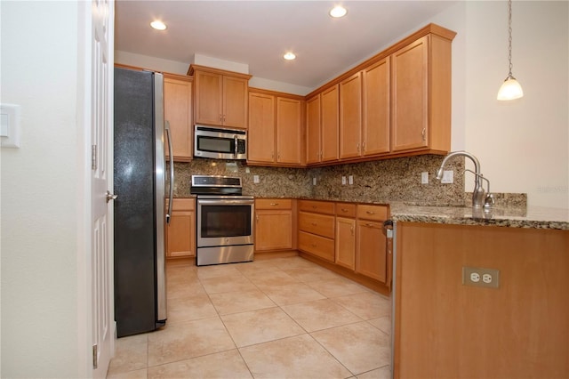 kitchen featuring light stone countertops, decorative light fixtures, stainless steel appliances, and decorative backsplash