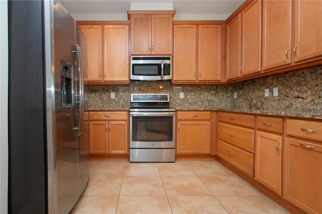 kitchen featuring light stone counters, light tile patterned floors, backsplash, and appliances with stainless steel finishes