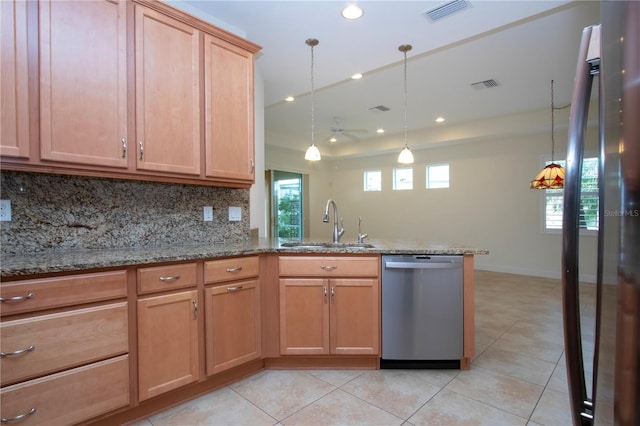 kitchen with sink, tasteful backsplash, dishwasher, pendant lighting, and light stone countertops