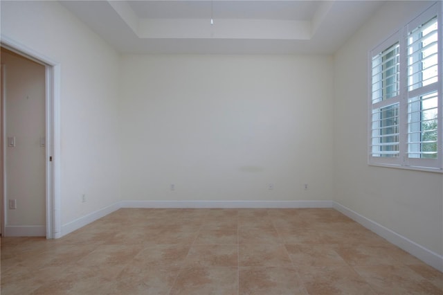 empty room featuring a tray ceiling