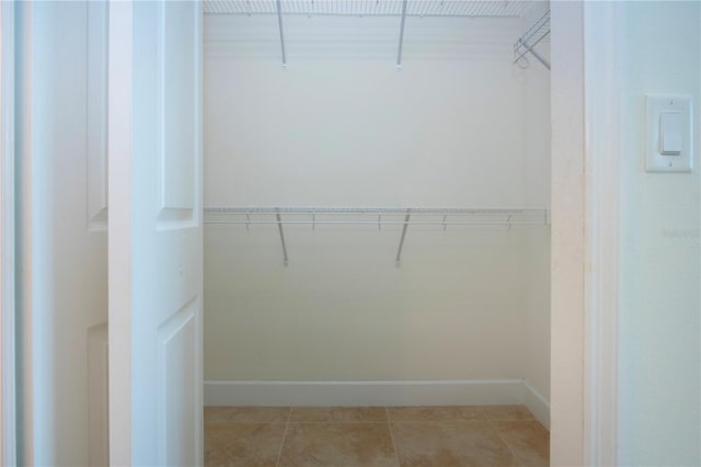 walk in closet featuring light tile patterned flooring