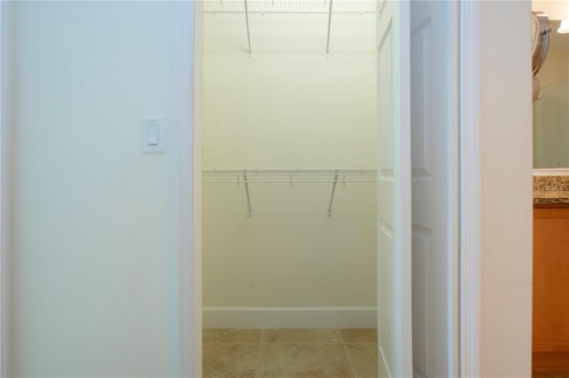 spacious closet featuring light tile patterned floors