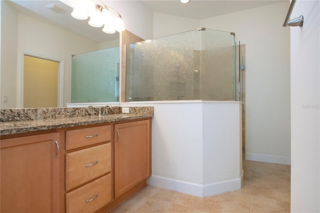 bathroom featuring vanity, tile patterned flooring, and walk in shower