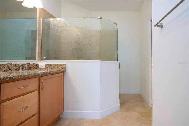 bathroom featuring vanity, tile patterned flooring, and a shower with door