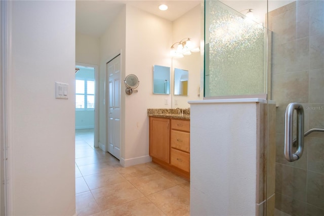 bathroom with vanity, a shower with shower door, and tile patterned flooring