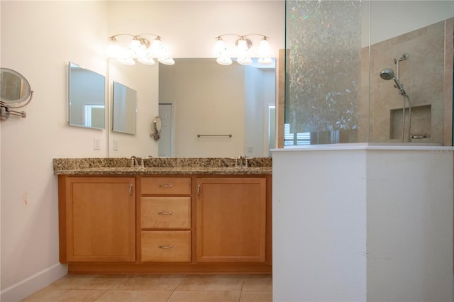 bathroom with vanity, tile patterned floors, and tiled shower