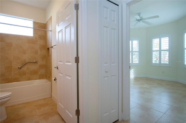 bathroom featuring tile patterned flooring, ceiling fan, tiled shower / bath combo, and toilet