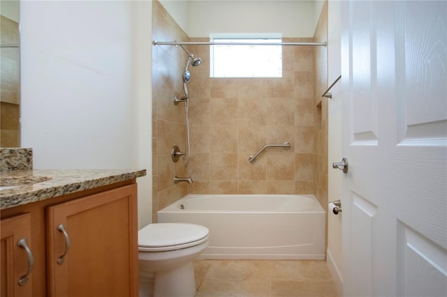 full bathroom featuring tiled shower / bath combo, vanity, tile patterned flooring, and toilet