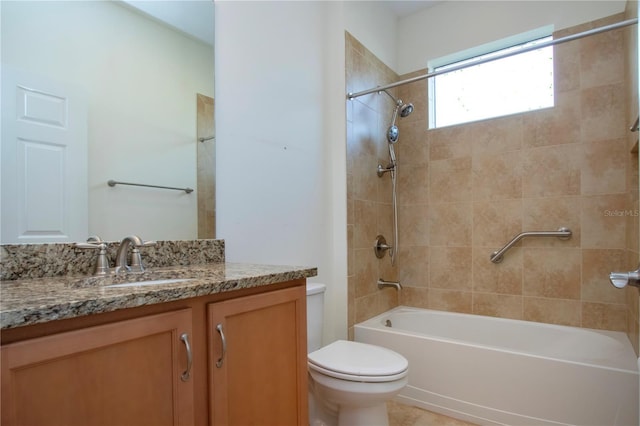 full bathroom featuring tiled shower / bath combo, vanity, and toilet