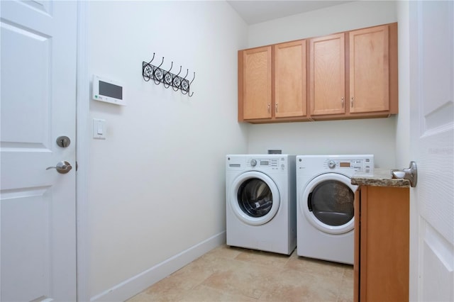 laundry room featuring cabinets and washing machine and clothes dryer