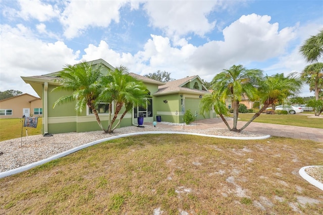 view of front of property with a garage and a front yard