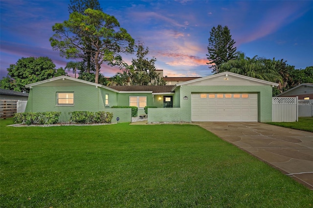 ranch-style home with a lawn and a garage