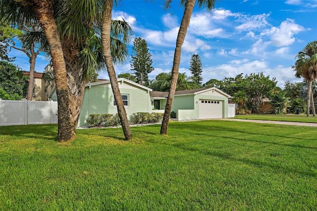 ranch-style house with a front yard and a garage