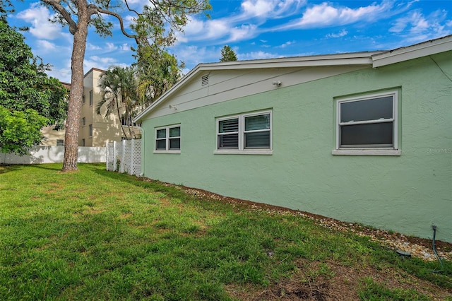 view of property exterior featuring a lawn