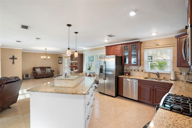 3887 50th Ave S, Saint Petersburg, FL 33711 - kitchen featuring appliances with stainless steel finishes, a sink, open floor plan, light tile patterned flooring, and light stone countertops