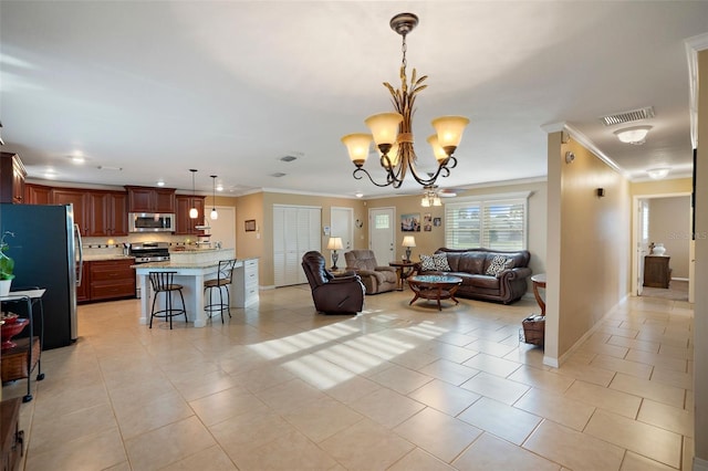 tiled living room featuring ornamental molding and ceiling fan with notable chandelier