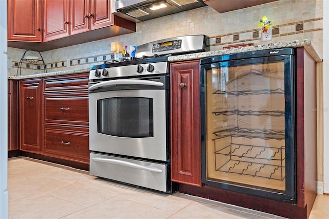 kitchen with wine cooler, tasteful backsplash, light tile patterned flooring, and stainless steel electric range oven