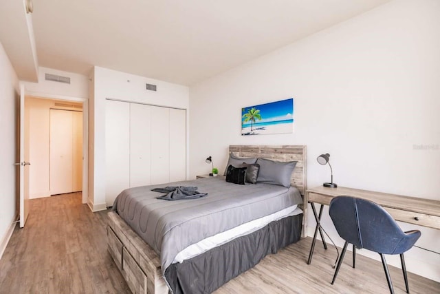 bedroom with a closet and light hardwood / wood-style floors