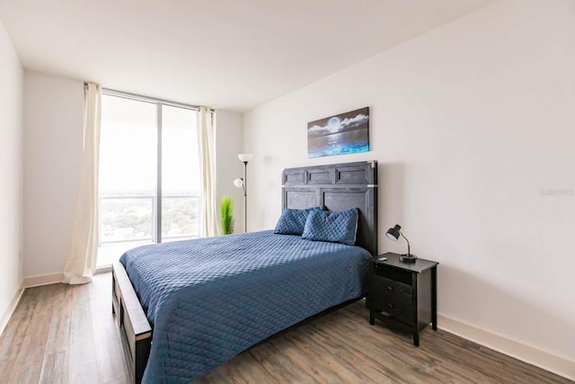 bedroom featuring dark hardwood / wood-style floors and floor to ceiling windows