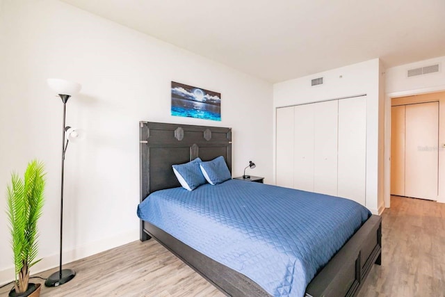 bedroom featuring a closet and light wood-type flooring