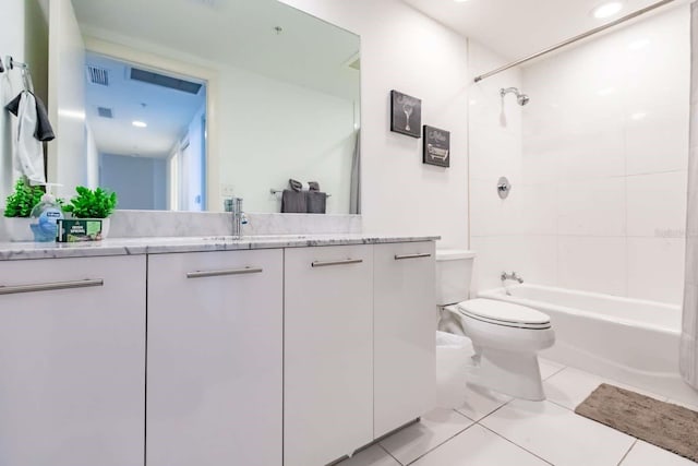 full bathroom featuring vanity, tiled shower / bath combo, toilet, and tile patterned flooring