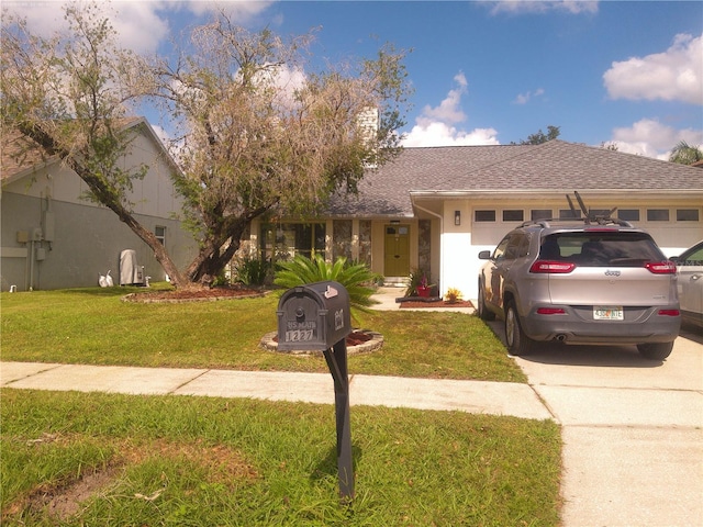 view of front facade with a front yard and a garage