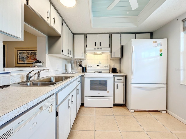 kitchen featuring decorative backsplash, sink, light tile patterned flooring, white cabinetry, and white appliances