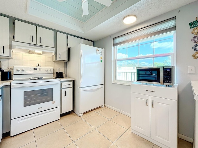 kitchen with a textured ceiling, tasteful backsplash, light tile patterned floors, ceiling fan, and white appliances