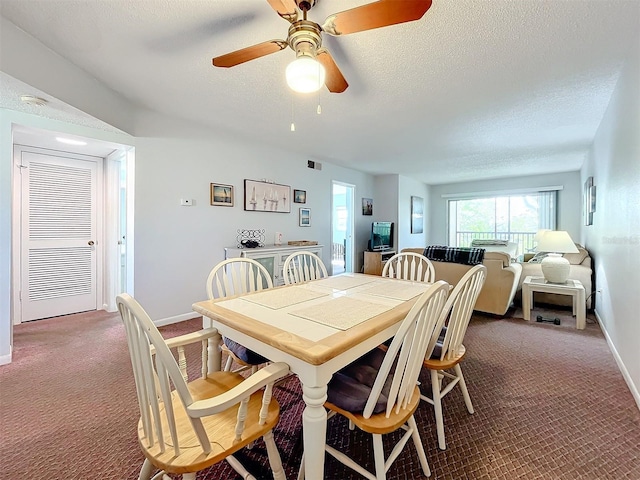 dining room with ceiling fan, a textured ceiling, and dark carpet