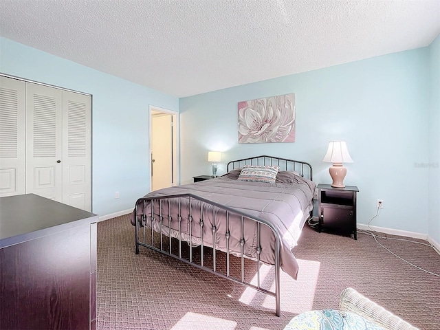 carpeted bedroom featuring a textured ceiling and a closet