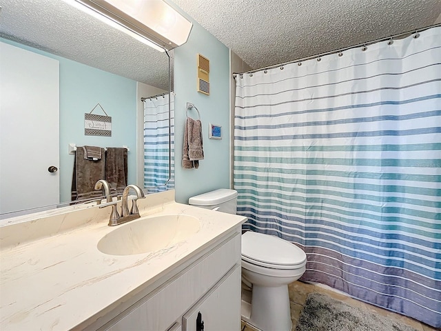 bathroom with tile patterned floors, vanity, toilet, and a textured ceiling