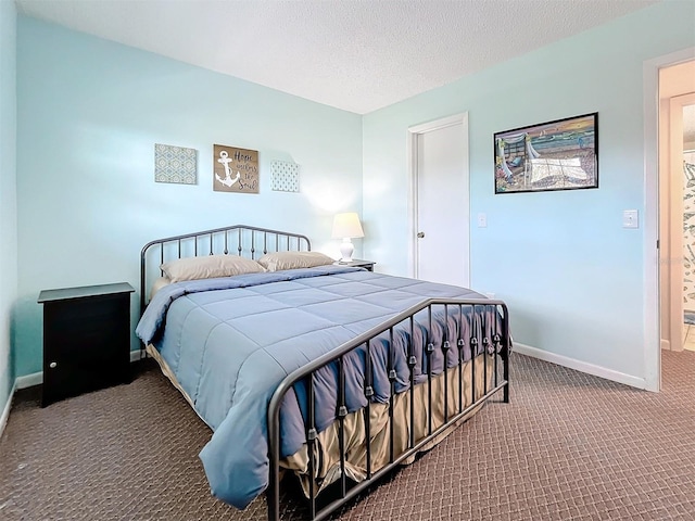 bedroom with a textured ceiling and carpet floors