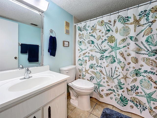 bathroom featuring walk in shower, tile patterned flooring, a textured ceiling, vanity, and toilet