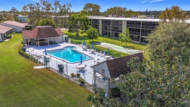 view of swimming pool featuring a lawn and a patio