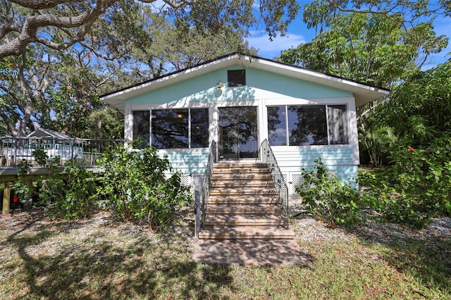 view of front facade featuring a deck and a sunroom