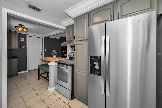 kitchen featuring light tile patterned flooring, appliances with stainless steel finishes, and gray cabinetry