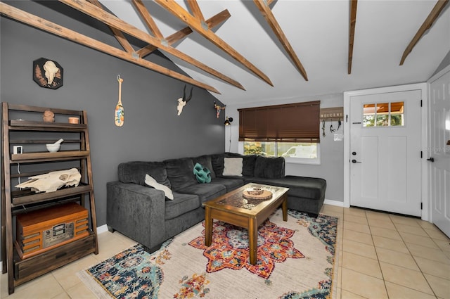 living room featuring lofted ceiling with beams and light tile patterned floors