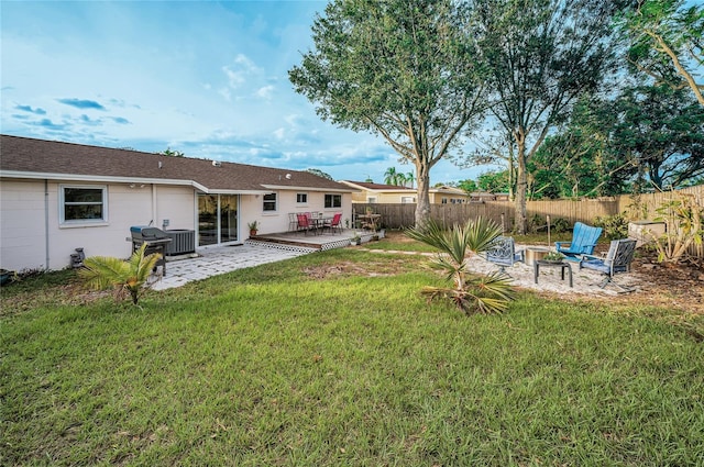 view of yard with a wooden deck, central AC, and a patio