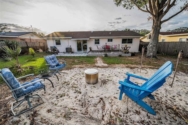 rear view of property with a deck and a patio