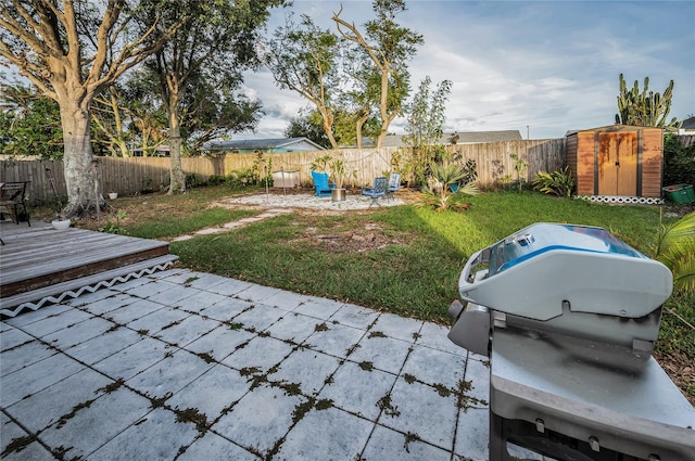 view of yard with a storage shed and a deck