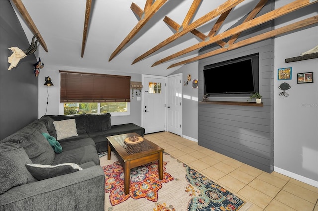 living room with light tile patterned floors and lofted ceiling with beams