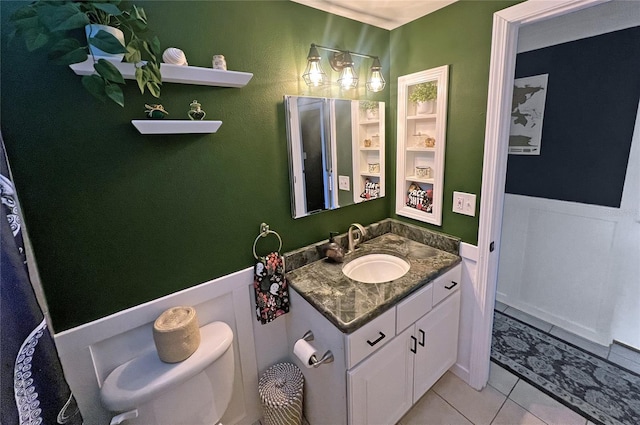 bathroom featuring tile patterned flooring, vanity, and toilet