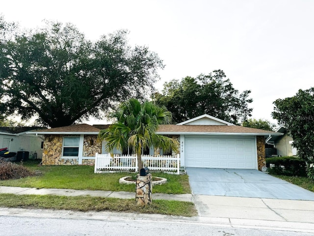 ranch-style house with a garage and a front lawn