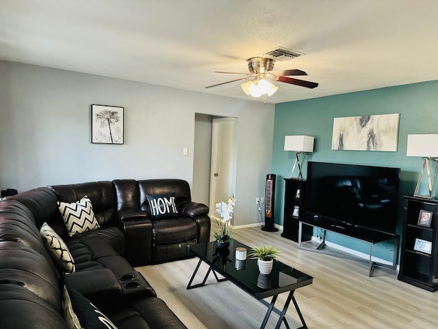 living room with light wood-type flooring and ceiling fan