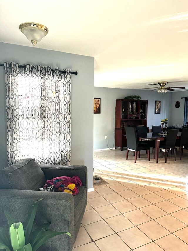 living room with ceiling fan and light tile patterned floors