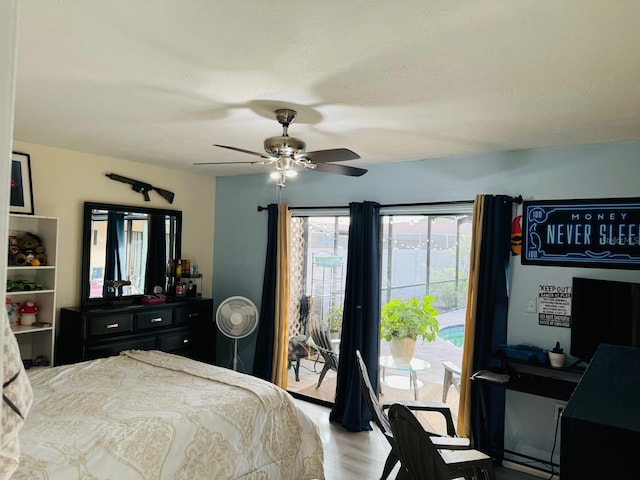 bedroom featuring ceiling fan, hardwood / wood-style flooring, and access to exterior