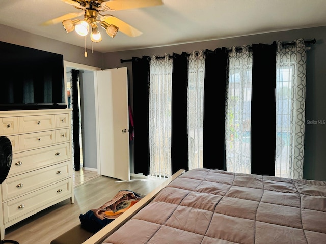 unfurnished bedroom with ceiling fan and light hardwood / wood-style flooring