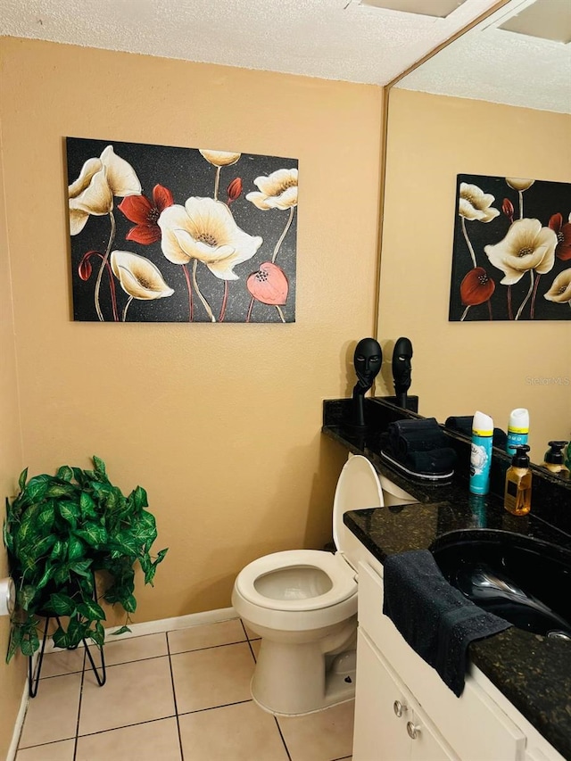 bathroom with tile patterned flooring, vanity, and toilet