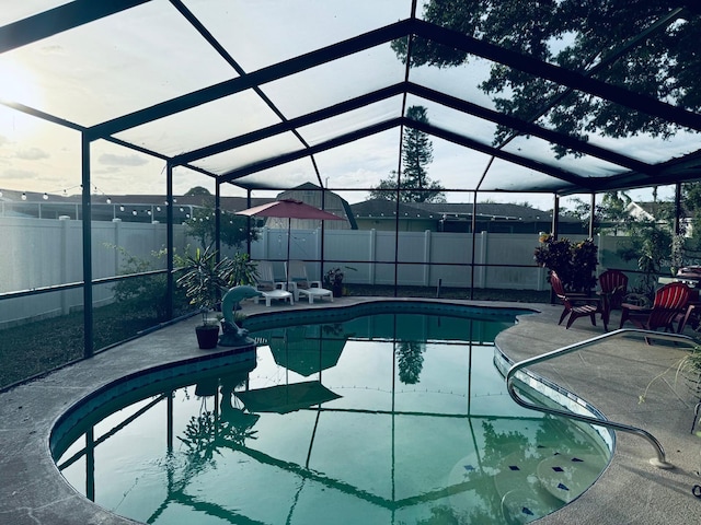 view of pool with a patio area and a lanai